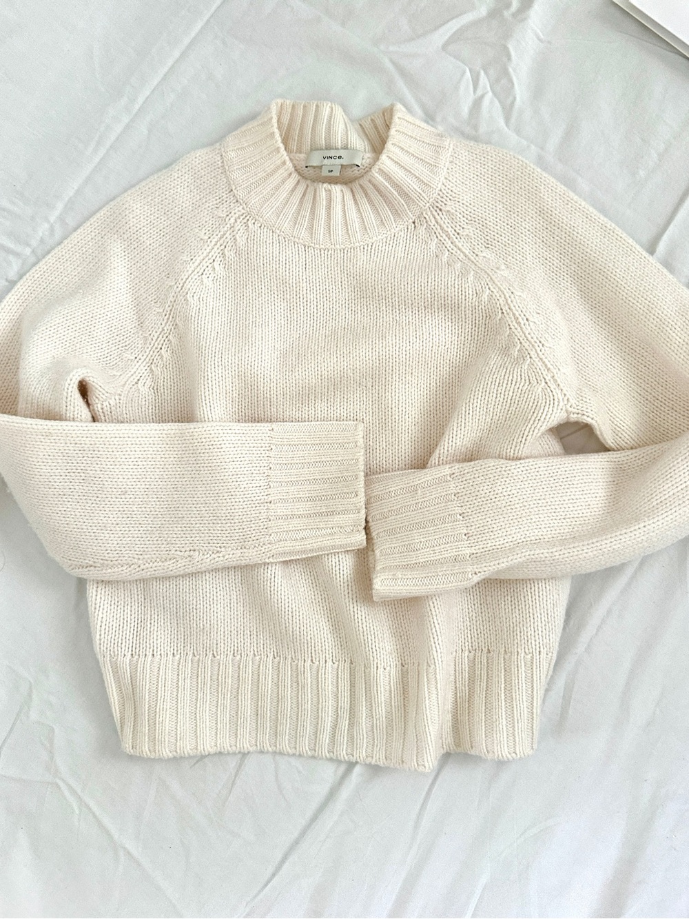 Vince cable-knit wool-blend sweater in a creamy white.